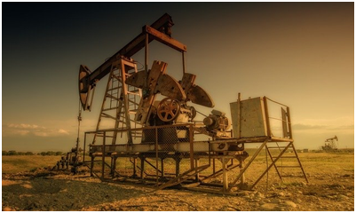 An old rig in a dusty field.